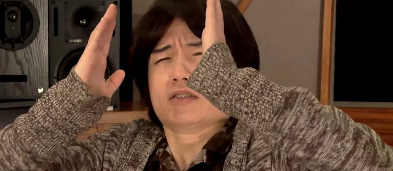 Sakurai holding hands up